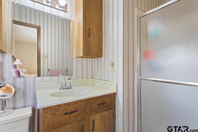 21187 Kristen Dr, Chandler, TX 75758 - bathroom featuring wallpapered walls, a stall shower, and vanity