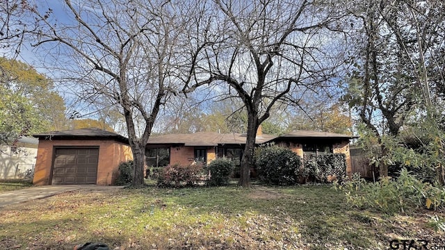 ranch-style home featuring a garage