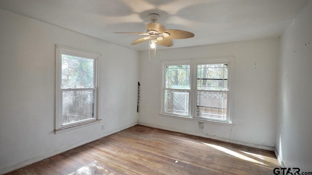 unfurnished room with plenty of natural light, ceiling fan, and light hardwood / wood-style flooring