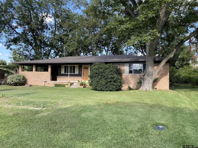 ranch-style home with brick siding and a front lawn