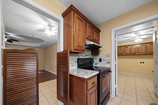 kitchen with light tile patterned floors, ceiling fan, tasteful backsplash, light stone countertops, and black / electric stove