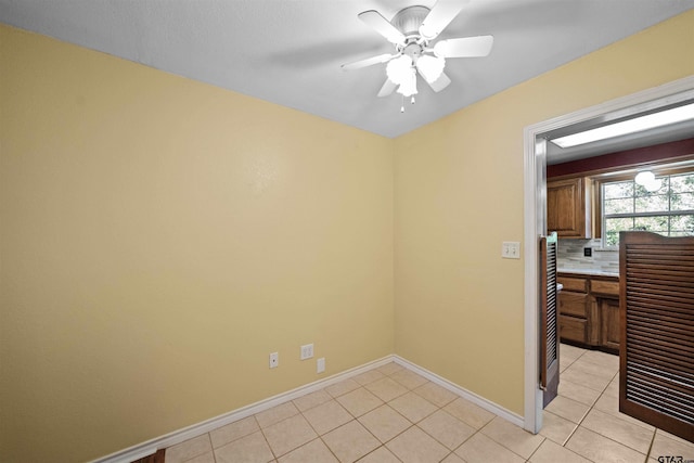 empty room featuring light tile patterned floors and ceiling fan