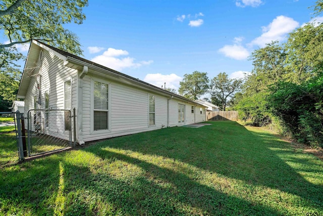 view of side of property featuring a yard