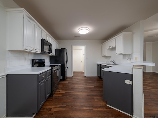 kitchen featuring white cabinetry, decorative backsplash, black appliances, and dark wood-type flooring