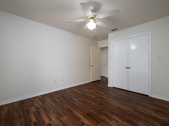 unfurnished bedroom with a closet, ceiling fan, and dark hardwood / wood-style floors