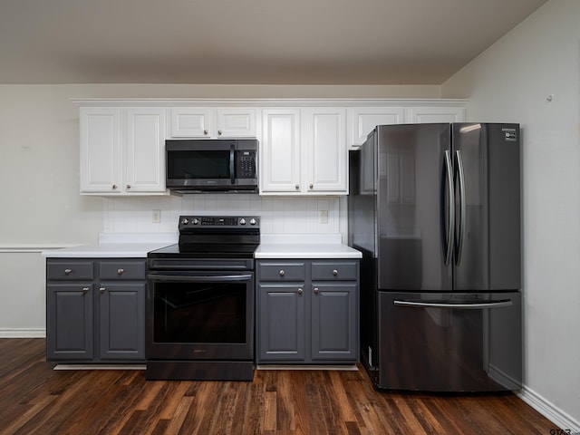 kitchen featuring dark hardwood / wood-style flooring, gray cabinetry, white cabinetry, and appliances with stainless steel finishes