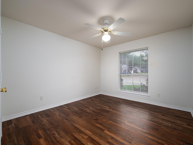 unfurnished room with dark hardwood / wood-style flooring and ceiling fan