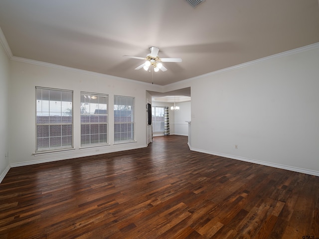 spare room featuring ceiling fan with notable chandelier, dark hardwood / wood-style floors, and crown molding