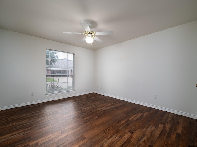 spare room featuring dark hardwood / wood-style flooring and ceiling fan