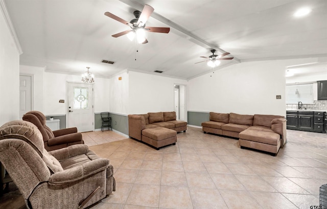 living room with ceiling fan, crown molding, light tile patterned floors, and vaulted ceiling