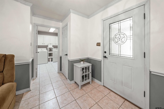 entrance foyer with light tile patterned flooring, washer and dryer, and ornamental molding