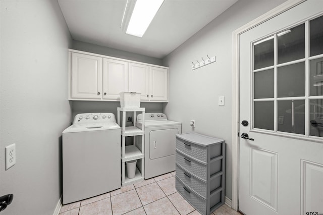 laundry area featuring cabinets, light tile patterned floors, and separate washer and dryer