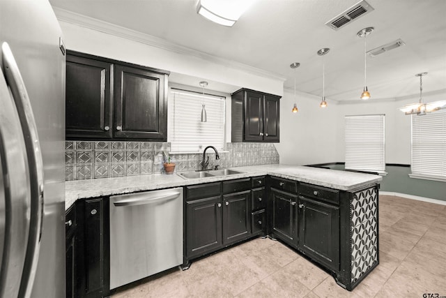 kitchen with stainless steel appliances, backsplash, pendant lighting, sink, and kitchen peninsula