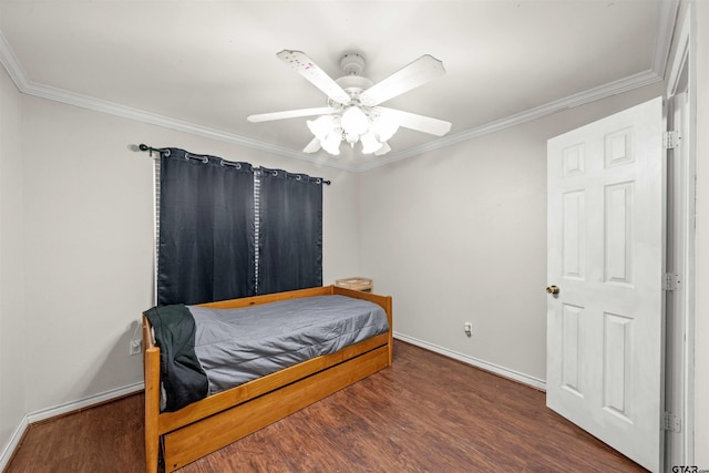 bedroom featuring dark hardwood / wood-style flooring, ceiling fan, and crown molding