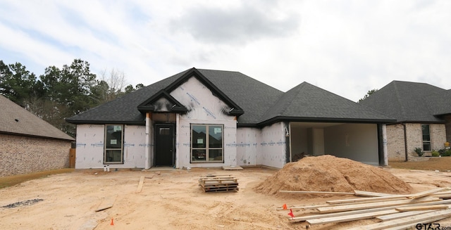 property under construction featuring a shingled roof