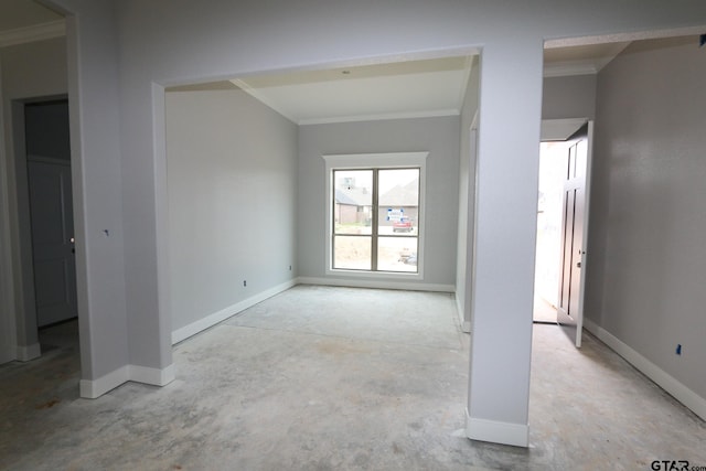 unfurnished room featuring baseboards, concrete flooring, and ornamental molding