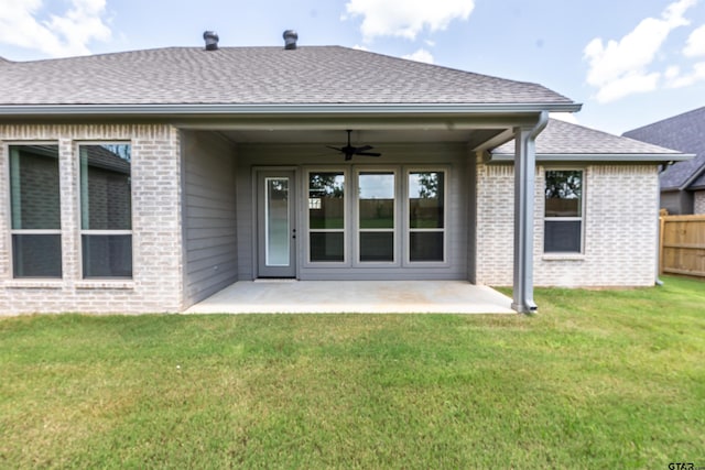 rear view of house with a yard, a patio, and ceiling fan