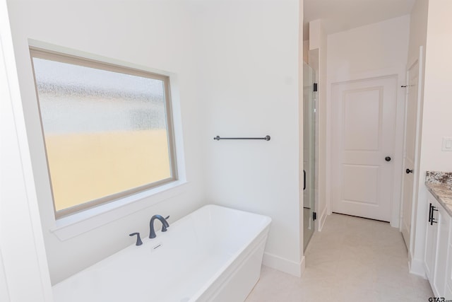 bathroom with vanity and independent shower and bath