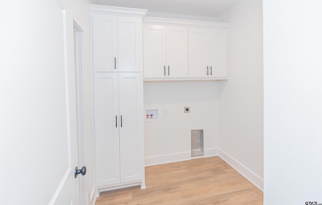 laundry area featuring cabinets, hookup for a washing machine, electric dryer hookup, and light wood-type flooring