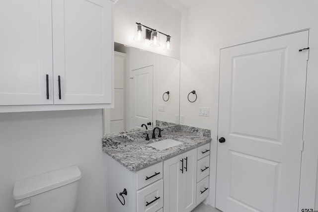 bathroom with toilet and vanity