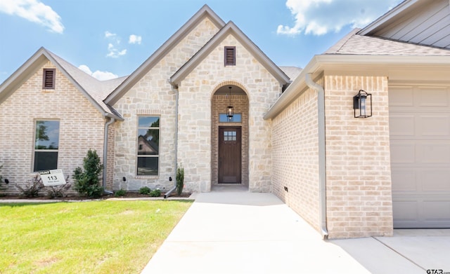 exterior space with a garage and a lawn