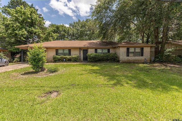 2114 Martin Luther King Blvd, Palestine, TX 75803 - ranch-style home with brick siding, a front yard, an attached carport, and driveway