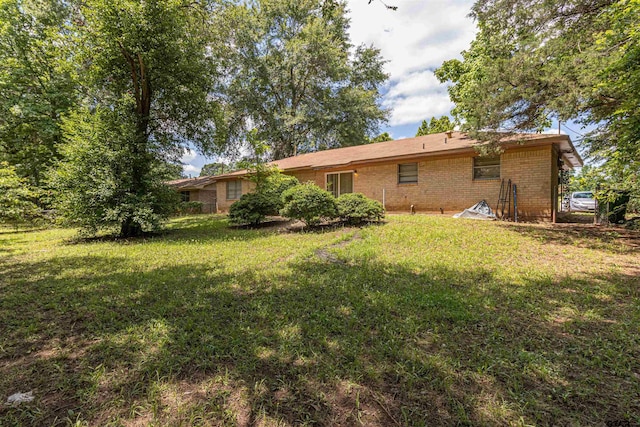 2114 Martin Luther King Blvd, Palestine, TX 75803 - back of property featuring a yard and brick siding