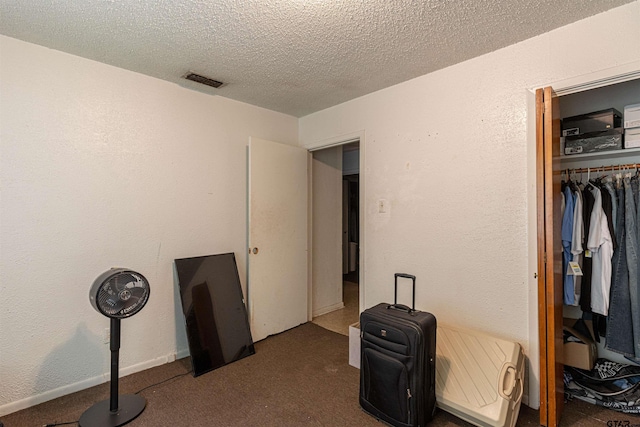2114 Martin Luther King Blvd, Palestine, TX 75803 - unfurnished bedroom featuring carpet floors, a closet, and a textured ceiling
