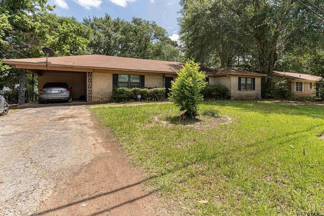 2114 Martin Luther King Blvd, Palestine, TX 75803 - ranch-style home featuring asphalt driveway, a front lawn, a carport, and brick siding