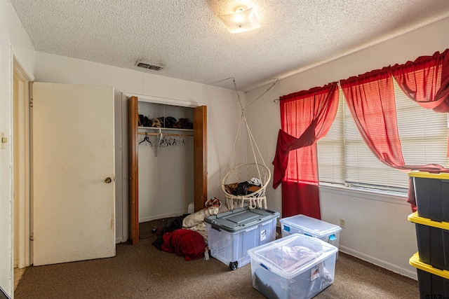 2114 Martin Luther King Blvd, Palestine, TX 75803 - bedroom featuring a textured ceiling, a closet, and carpet flooring