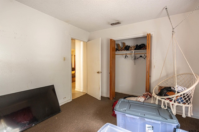 2114 Martin Luther King Blvd, Palestine, TX 75803 - bedroom with carpet floors, a textured ceiling, and a closet