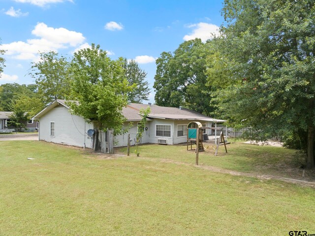 rear view of property with a yard