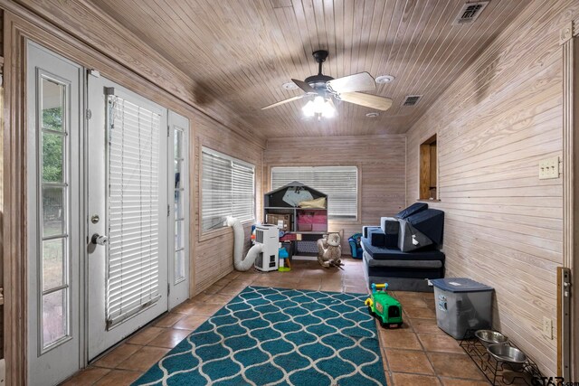 sunroom with wooden ceiling, visible vents, and ceiling fan