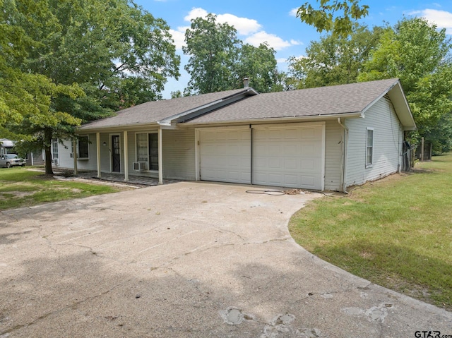 ranch-style home with a front lawn and a garage