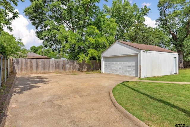 detached garage featuring fence