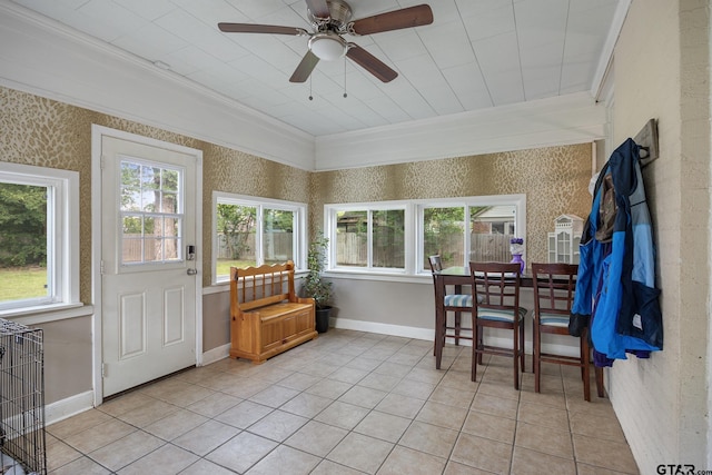 sunroom / solarium with crown molding, tile patterned floors, wallpapered walls, and baseboards