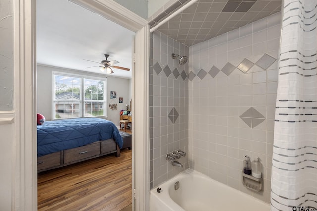 ensuite bathroom with connected bathroom, a ceiling fan, wood finished floors, and shower / tub combo with curtain