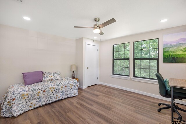 702 W Paschal St, Troup, TX 75789 - bedroom with wood finished floors, recessed lighting, a ceiling fan, and a desk
