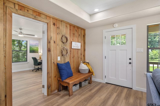 702 W Paschal St, Troup, TX 75789 - foyer entrance featuring light wood-style flooring, ceiling fan, and wood walls