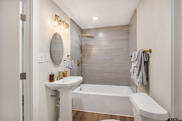 702 W Paschal St, Troup, TX 75789 - bathroom with bathtub / shower combination, wood finished floors, and recessed lighting