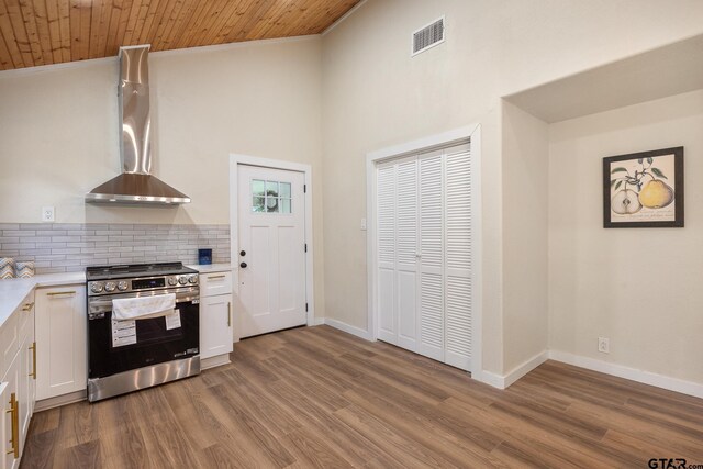 702 W Paschal St, Troup, TX 75789 - kitchen featuring stainless steel range with electric stovetop, white cabinetry, light countertops, ornamental molding, and a high ceiling