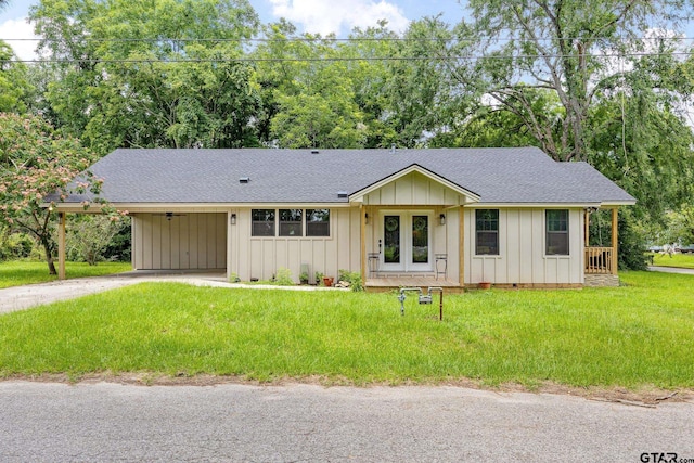 702 W Paschal St, Troup, TX 75789 - view of front of property with board and batten siding, a carport, roof with shingles, and driveway