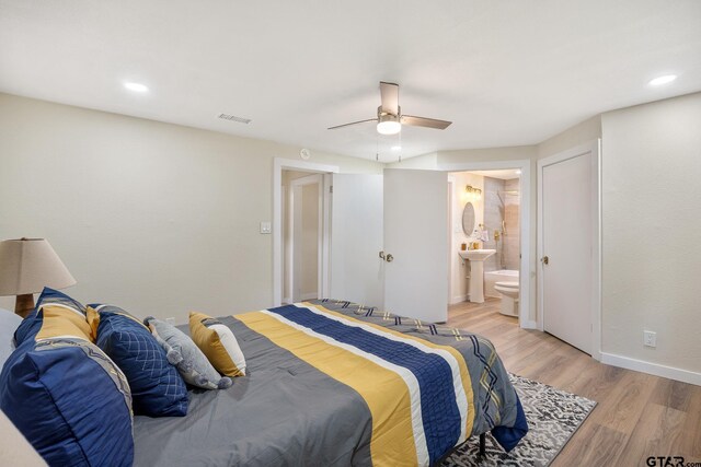 702 W Paschal St, Troup, TX 75789 - bedroom with light wood-style flooring, ceiling fan, ensuite bath, and recessed lighting