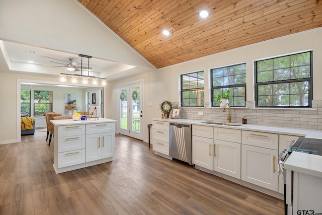 702 W Paschal St, Troup, TX 75789 - kitchen featuring stainless steel dishwasher, stove, light countertops, ceiling fan, and decorative backsplash