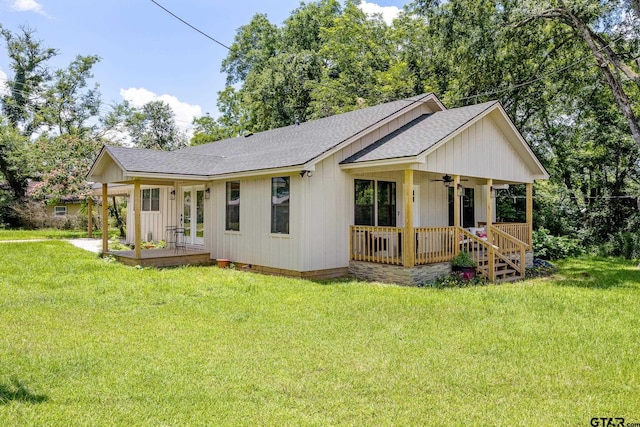 702 W Paschal St, Troup, TX 75789 - view of front of house with roof with shingles, covered porch, ceiling fan, and a front lawn