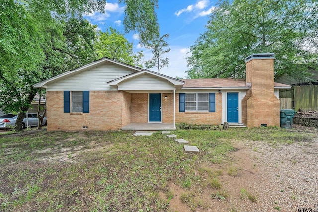 ranch-style home with brick siding, a chimney, crawl space, and fence