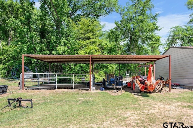 view of yard with a carport, an outdoor structure, and an exterior structure