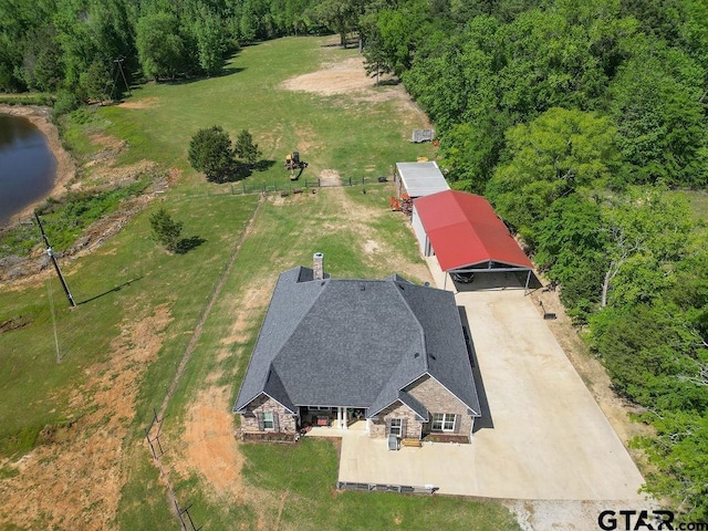 birds eye view of property featuring a wooded view