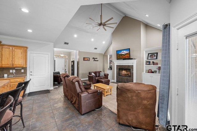 living area featuring visible vents, recessed lighting, built in features, ceiling fan, and a fireplace
