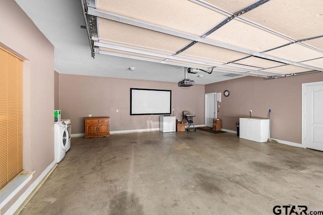 garage featuring baseboards, washer and dryer, and a garage door opener